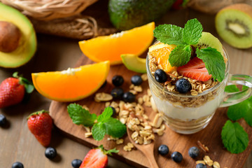 Granola and yogurt and fruits on topping in glass