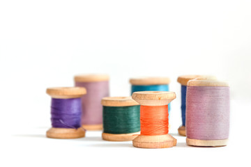 spool of thread isolated on white background in soft focus, sewing supplies and accessories for needlework, multicolored thread coils for sewing clothes