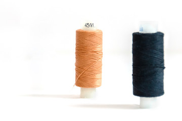 beige skein and black in soft focus isolated on white background