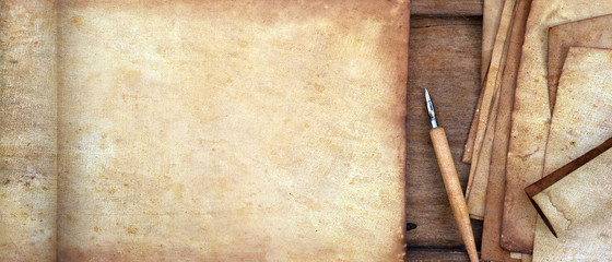 old paper on brown wood texture with pen for background                