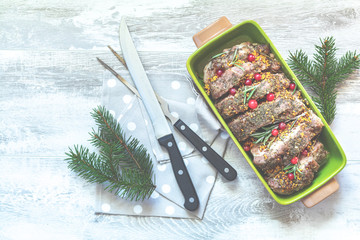 Delicious baked meat with cranberry and spices. Christmas table place setting. Holidays background