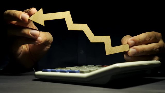 Man is holding arrow in the hands as a symbol. Increase or reduce in business trading.