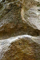 Fototapeta na wymiar climbing sign on sandstone rock in Fontainebleau forest