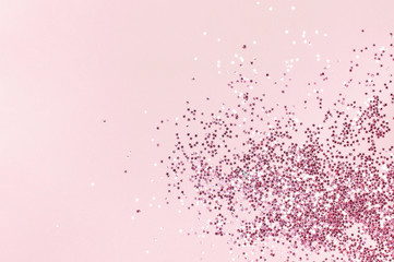 Pink holographic glitter confetti in the form of stars on pink background Flat lay top view copy space. Festive holiday pastel backdrop. Birthday, congratulations, Christmas, New Year