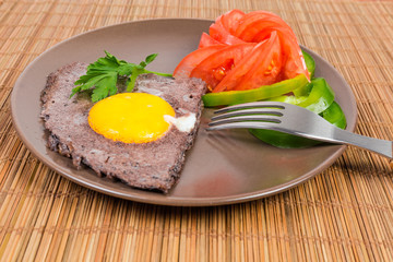 Fried egg with beaten egg white with black olives