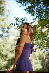 Street fashion concept: full body portrait of young beautiful woman walking in the city. Model looking aside. Toned and Filtered Photo.