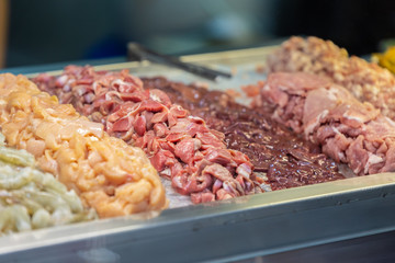 pieces cut raw meat prepare for cooking wait on ice in restaurant kitchen