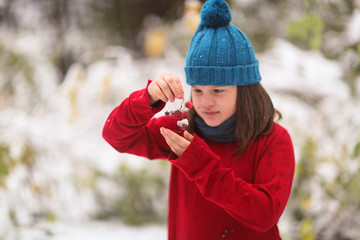 Raspberry berries and snow, child holds in hands