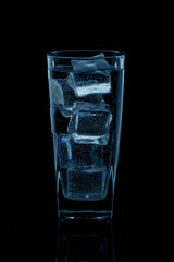 Silhouette of a glass with water on a black background