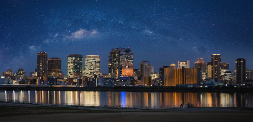 Panoramic building at night in Osaka city with starry sky