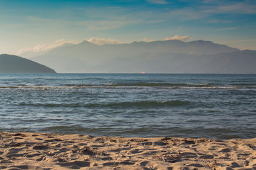 Overlooking Thassos Island, dressed in fog. From Keramoti beach, a charming resort town on the Aegean coast in northern Greece.