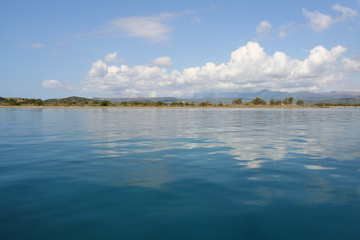Beautiful blue mediterranean sea with clouds reflecting near Gialova, Greece