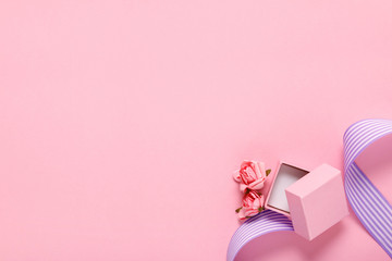pink gift box and flowers on pink background