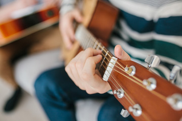 Learning to play the guitar. Interesting hobby or professional occupation of music. Music education...
