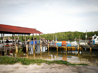 People disembark from the passenger boat in the morning in Merang village.