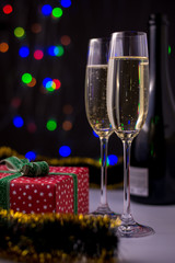 Christmas decoration with two glasses of champagne and lights.
