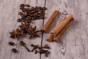 Spices and coffee beans on wooden table.