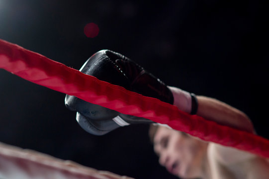 boxer's hand on the ring rope