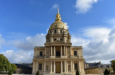 Paris, France. Les Invalides. Facade and golden dome. Blue sky with clouds.