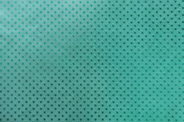 Dark turquoise background from metal foil paper with a stars pattern