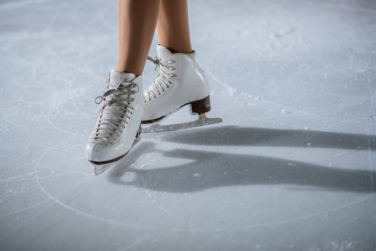 White skates on the ice. A young dancer is having her performance.