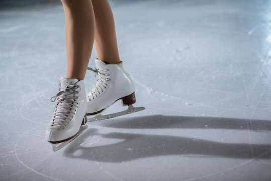 A young girl in her initial position before her show on the ice.
