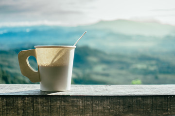 Hot Coffee in paper cups and mountain views in the morning.