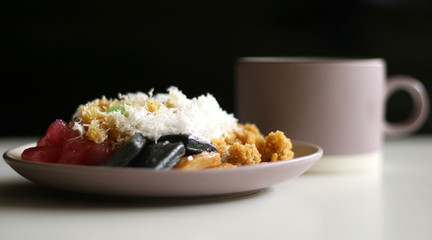 Cenil with grated coconut and sugar. Cenil is traditional cake from Java, Indonesia. Made from starch. 