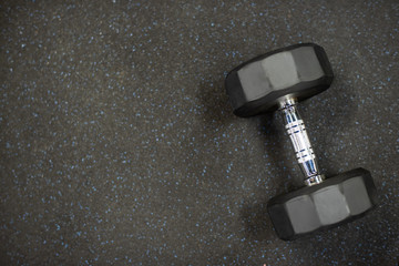 Dumbbell on black rubber floor in gym for exercise. - 234240587