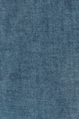 Old blue denim jeans texture or background with visible fibers