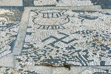 Ostia antica in Rome, Italy. Mosaic on the Shop Floor in Piazzale delle Corporazioni with Swastika a geometrical figure and an ancient religious icon from the cultures of Eurasia