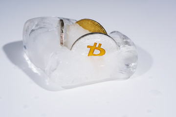 Obraz na płótnie Canvas Abstract photo of cryptocurrency. Frozen coins in ice