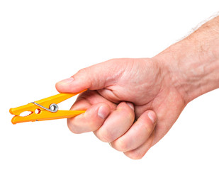 Color clothespin in male hand isolated on white background. Man hand with colourful clothes-pin - close-up.