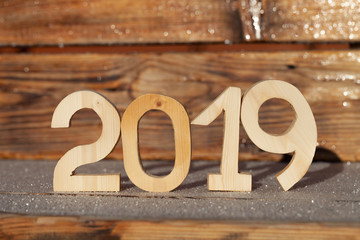 Wooden number 2019 on wooden background. Happy new Year 2019.