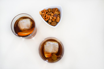 Two glasses of vermouth on table with snack top view