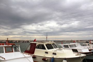 Sunset with boats and storks docked.