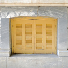 pale orange french style window shutters closeup