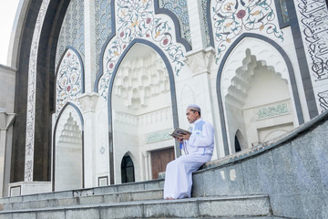 Middle age muslim man praying at mosque.