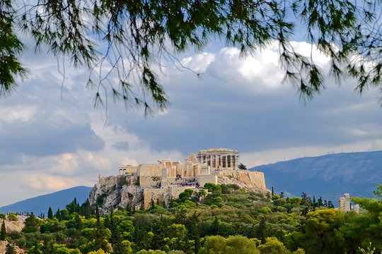Acropolis of Athens Greece, under a blue but cloudy sky