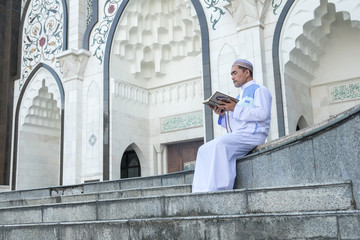 Middle age muslim man praying at mosque.