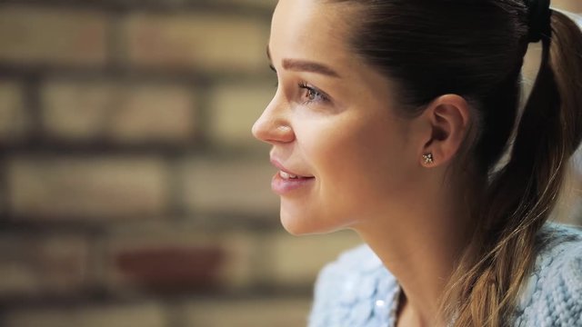 Profile view of beautiful woman face listening an interlocutor in a cafe