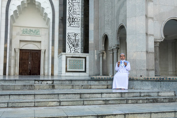 Middle age muslim man praying at mosque.