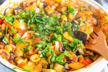 Cooking caponata in a large frying pan
