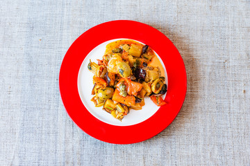 Caponata siciliana on a beautiful plate close-up, top view