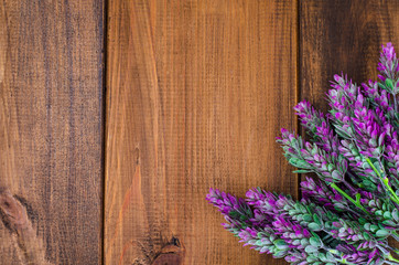 Wooden natural brown background with lilac flowers for text