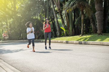 young cheerish asian woman  excecise in a park at morning