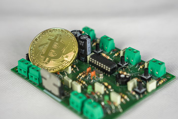 Bitcoin coin on computer circuit