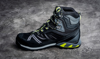 Black hiking boot on the dark table