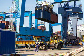 industrial port with containers. Container terminal of industrial port with cranes and ships at work