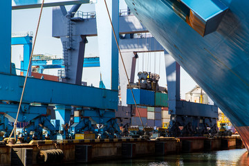 industrial port with containers. Container terminal of industrial port with cranes and ships at work